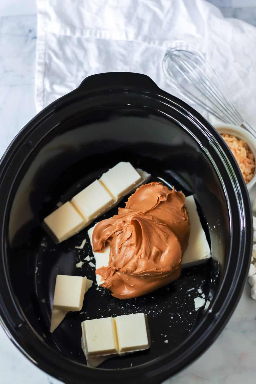 Almond bark and peanut butter added to crock pot.