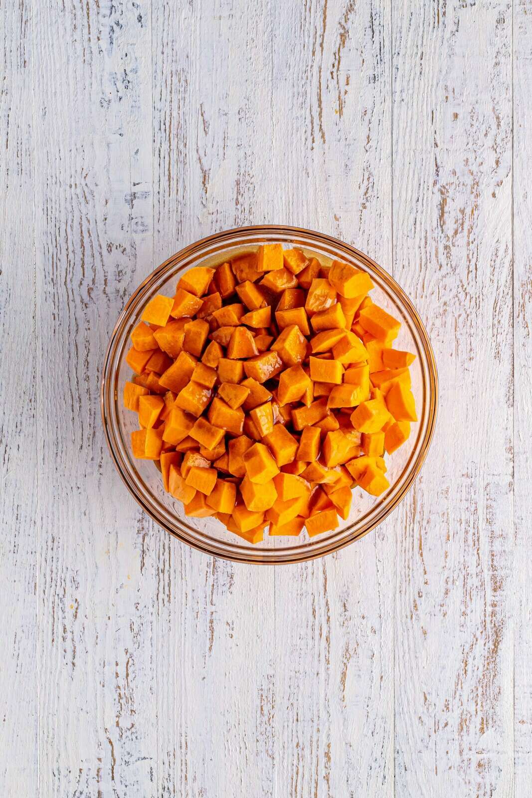 Brown sugar mixture poured over sweet potatoes in bowl and stirred in.
