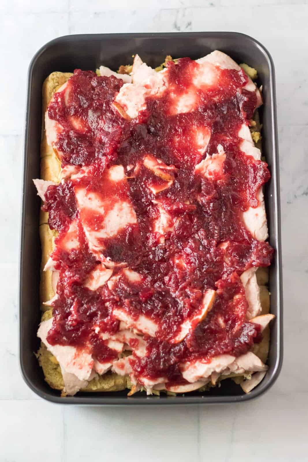 Cranberry sauce spread over the top of the turkey.