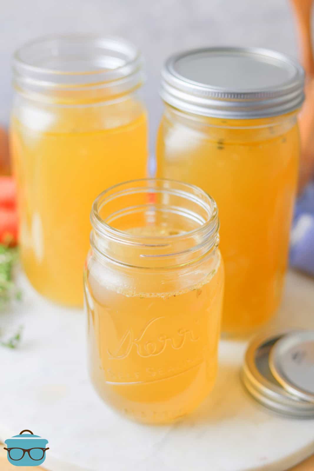 Homemade Chicken Broth in mason jars 2 with lids off.