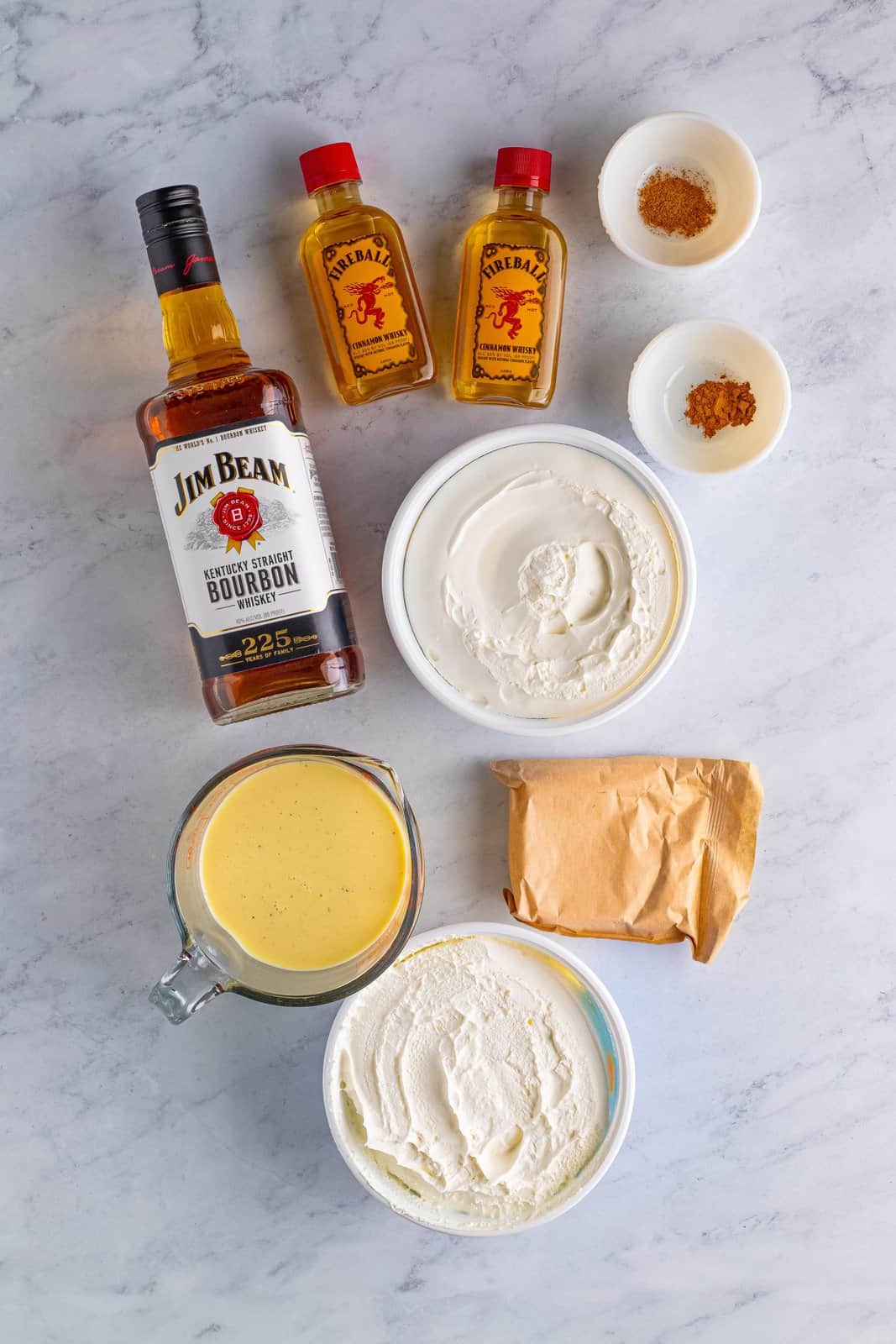 Ingredients needed: instant vanilla pudding mix, eggnog, bourbon, fireball cinnamon whiskey, ground cinnamon, ground nutmeg and whipped topping.