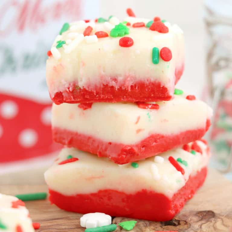 Close up square image of stacked Christmas Cake Batter Fudge.