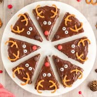 Close up overhead square photo of Reindeer Cookie Bars on white round platter.