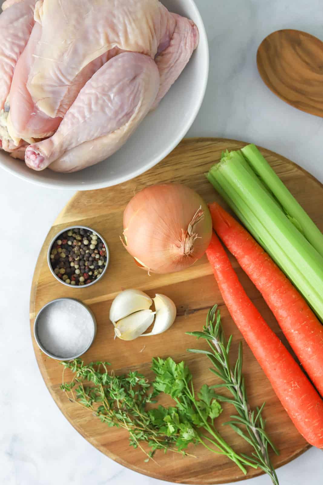 Ingredients needed: whole chicken, celery stIcks, carrots, garlic, onion, cooking oil, water, rosemary, thyme, parsley, bay leaf, whole peppercorns and salt.