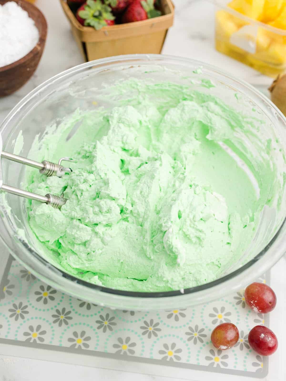 Green whipped cream mixed together in bowl.