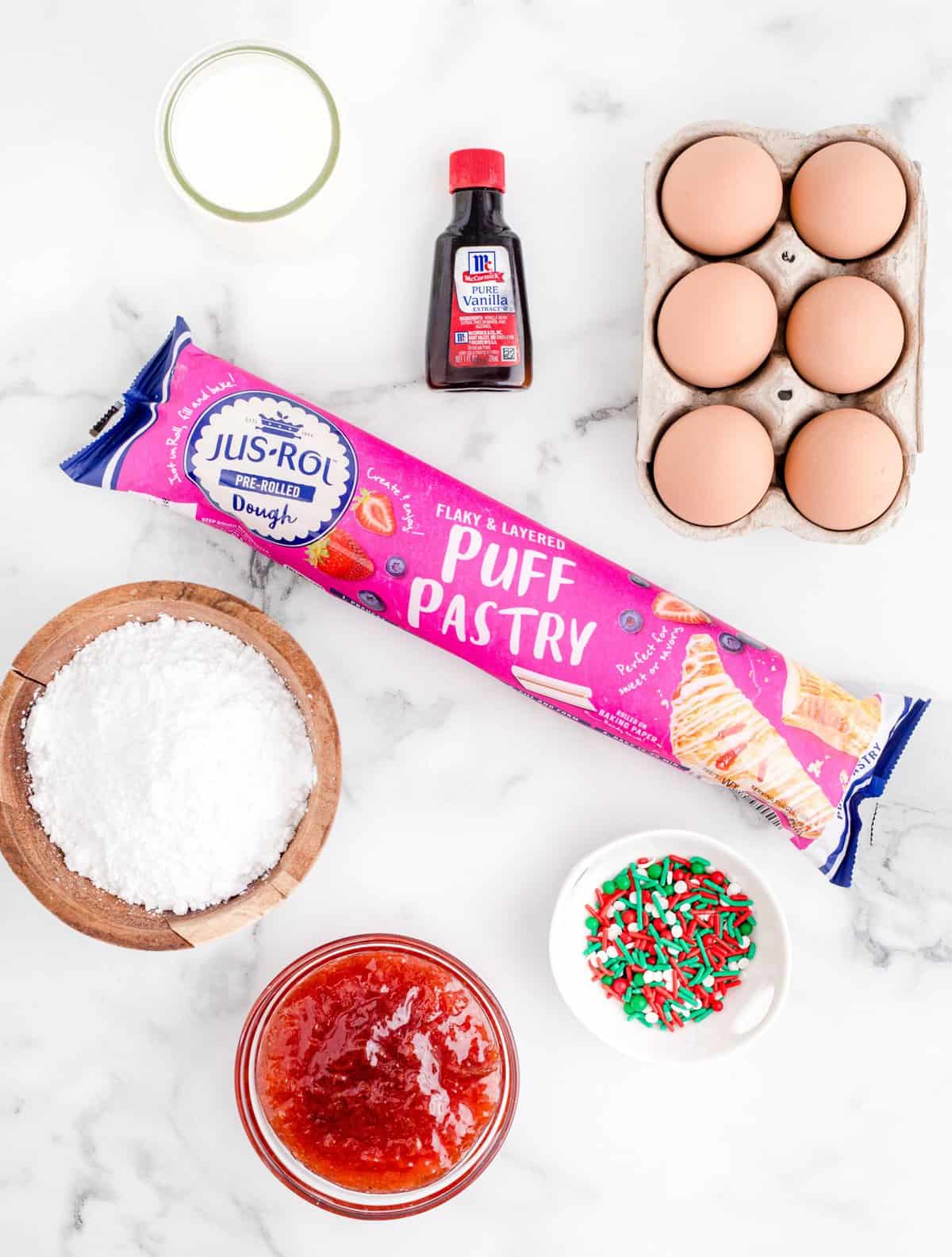 Ingredients needed: puff pastry, strawberry preserves, egg, powdered sugar, milk, vanilla extract and sprinkles.