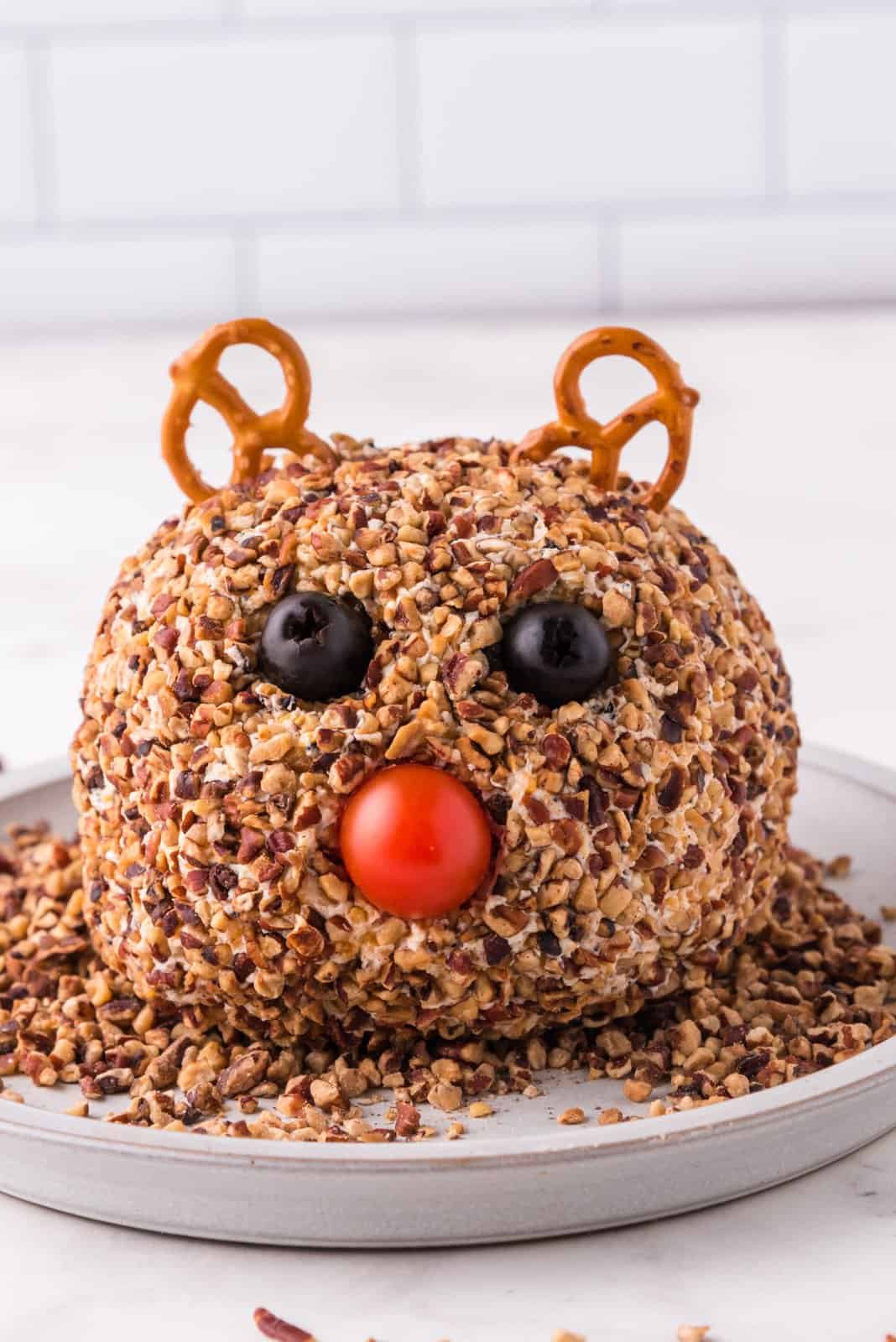 Pretzels, olives and tomato added to cheeseball to make a face.
