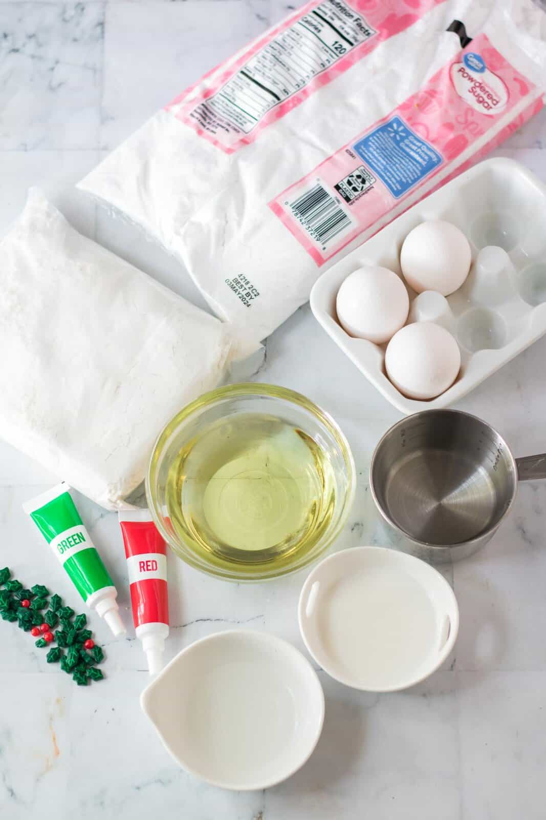 white cake mix, eggs, powdered sugar, oil, almond extract, read and green food coloring. 