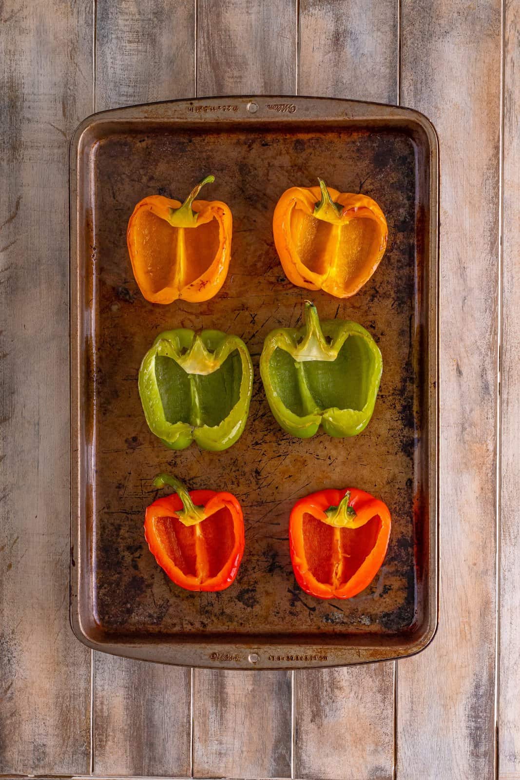 baked sliced bell peppers on a baking sheet. 