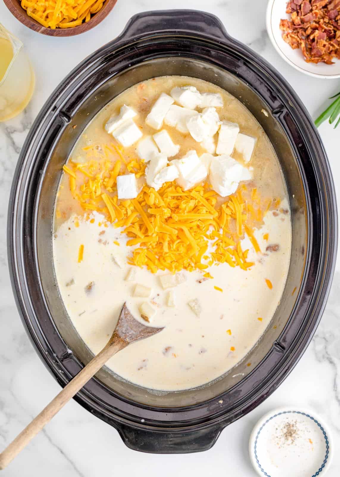cream cheese and shredded cheddar cheese added to potato soup. 