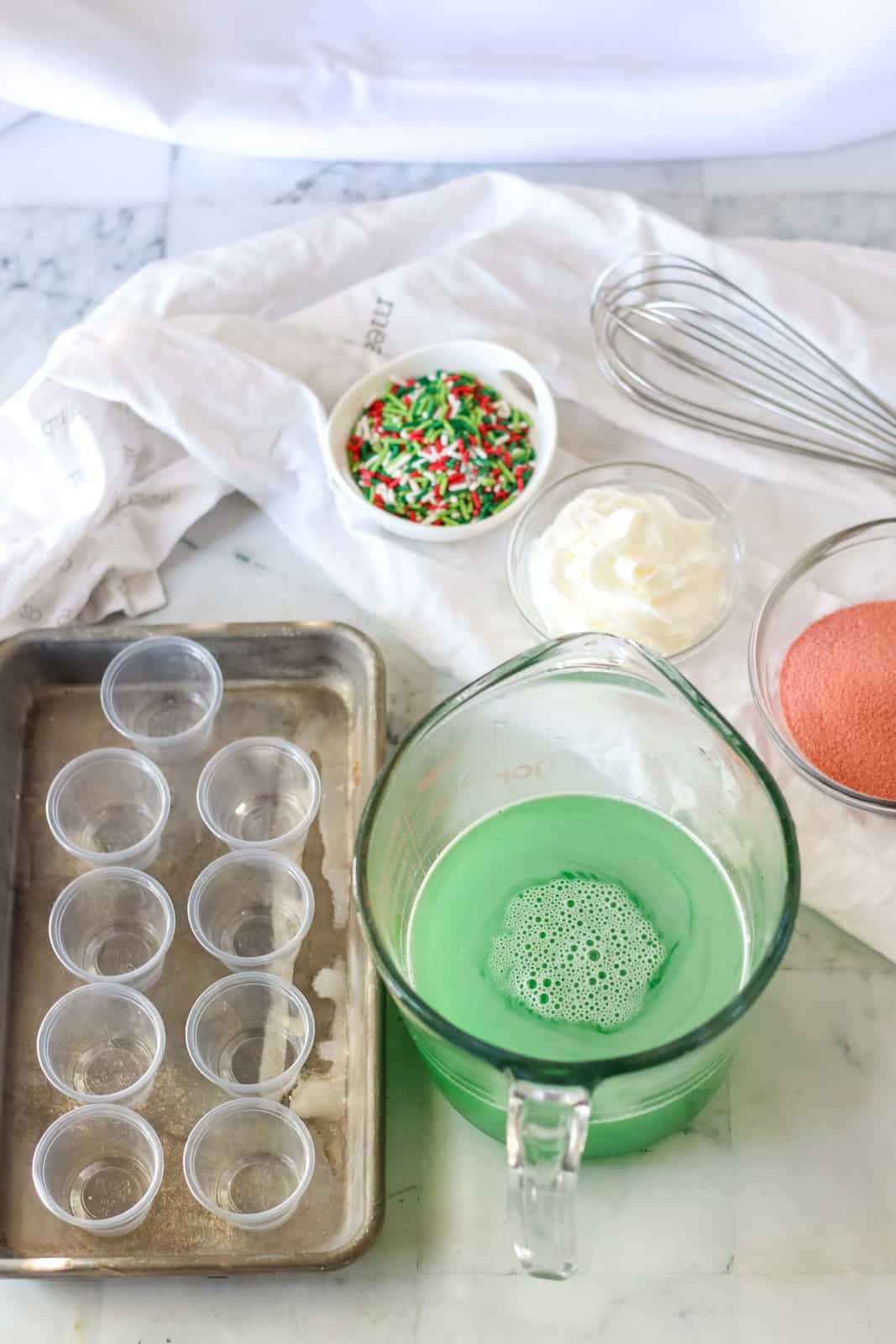 Green Jell-O mixture being prepared in large measuring cup.