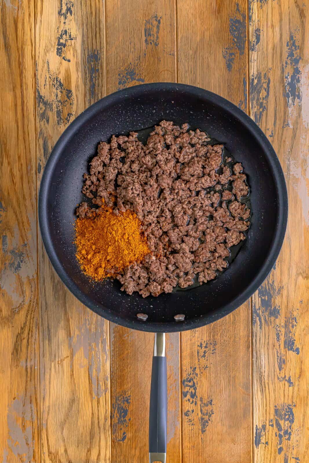 taco seasoning and water added to ground beef in skillet. 
