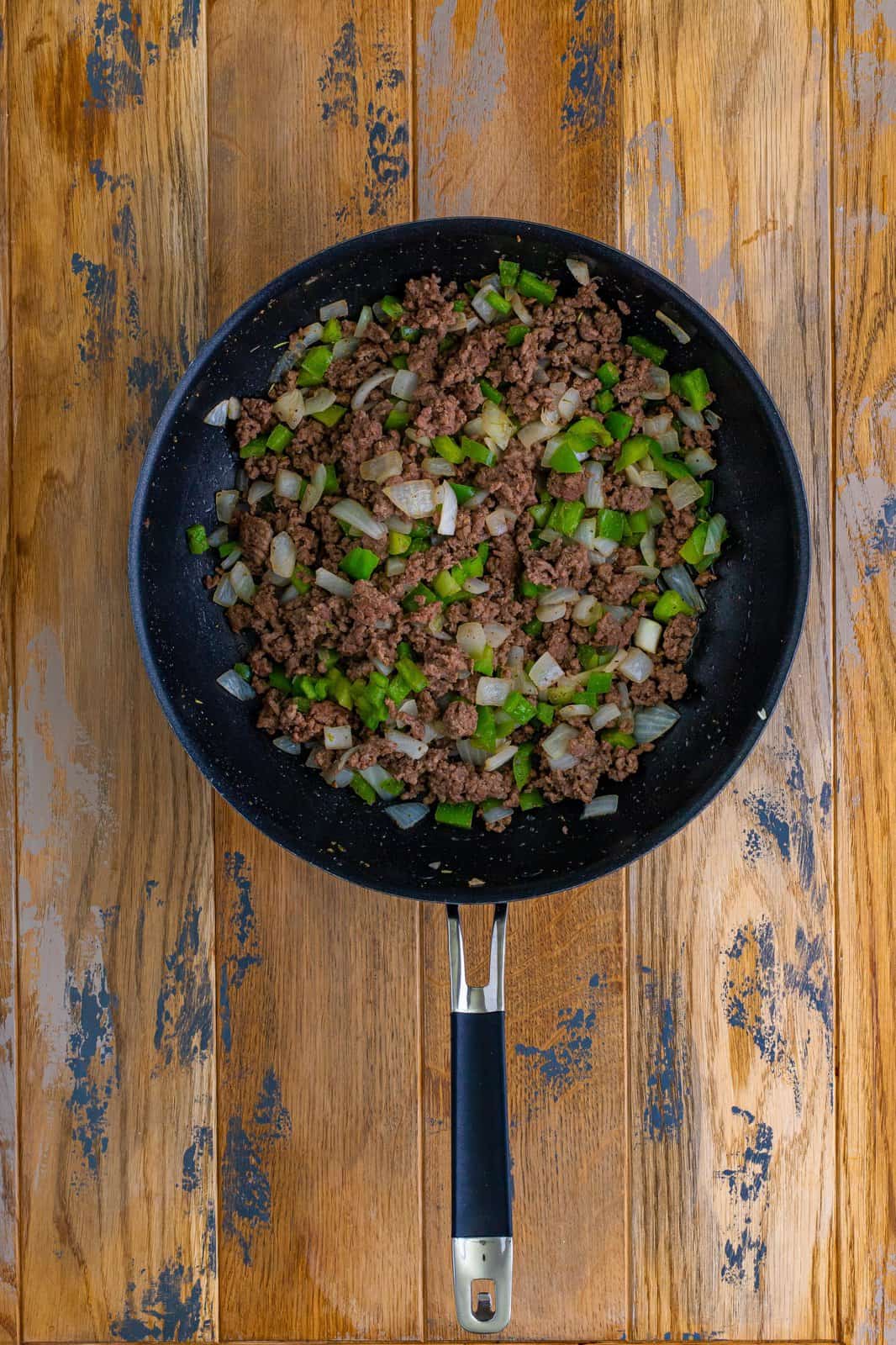 cooked and crumbled ground beef, onions and green peppers in a large skillet. 
