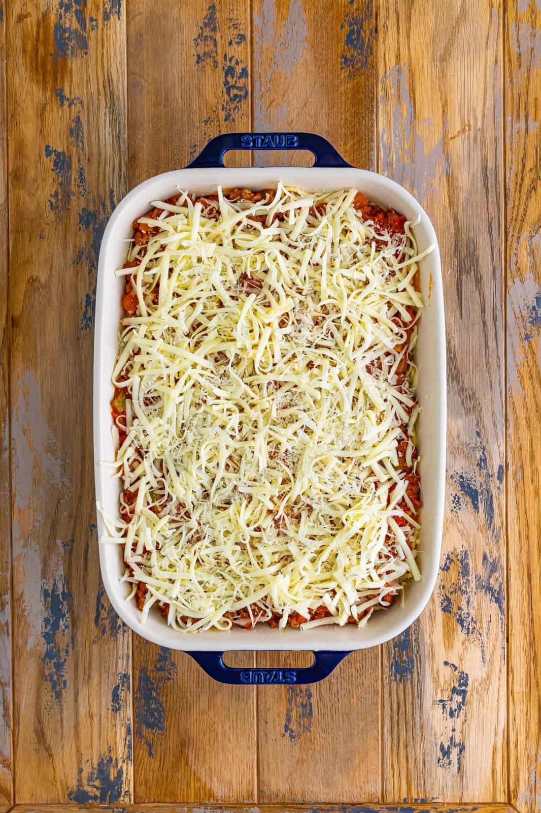 shredded Mozzarella and Parmesan cheese sprinkled evenly over the top of the casserole. 