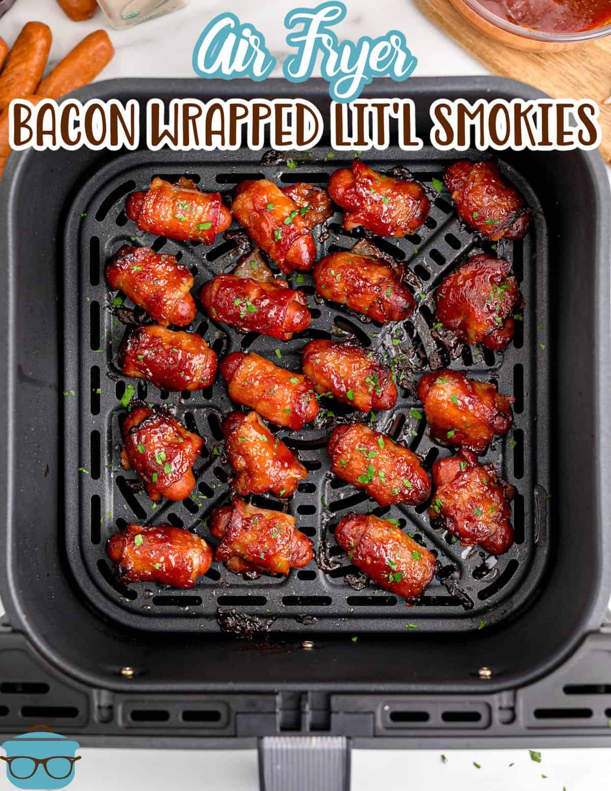 fully cooked bacon wrapped little smokies shown in an air fryer basket.