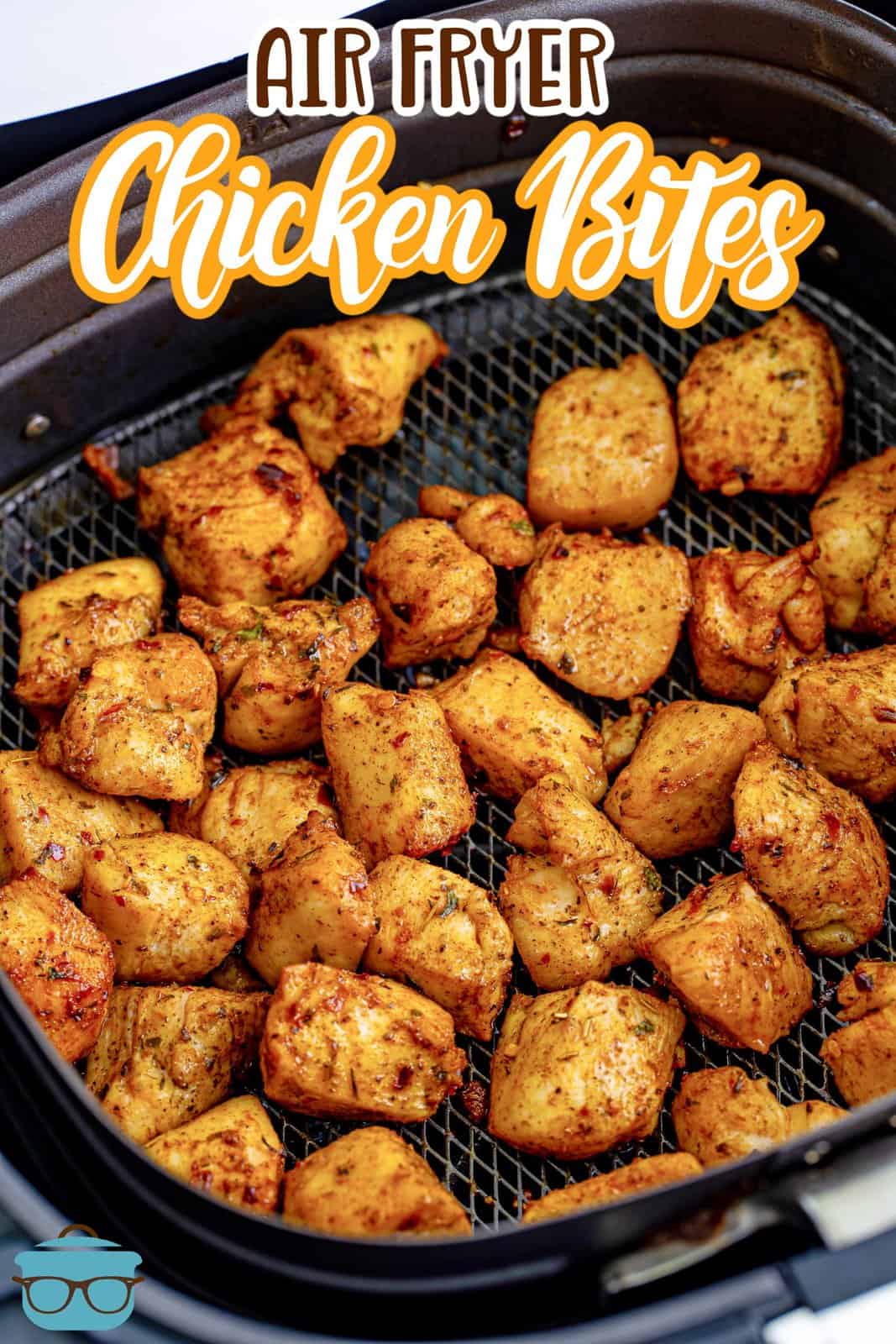 Fully cooked and seasoned chicken breast bites shown in a black air fryer basket. 