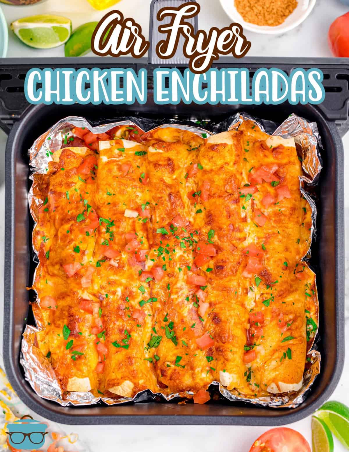 fully cooked chicken enchiladas shown in an air fryer basket.