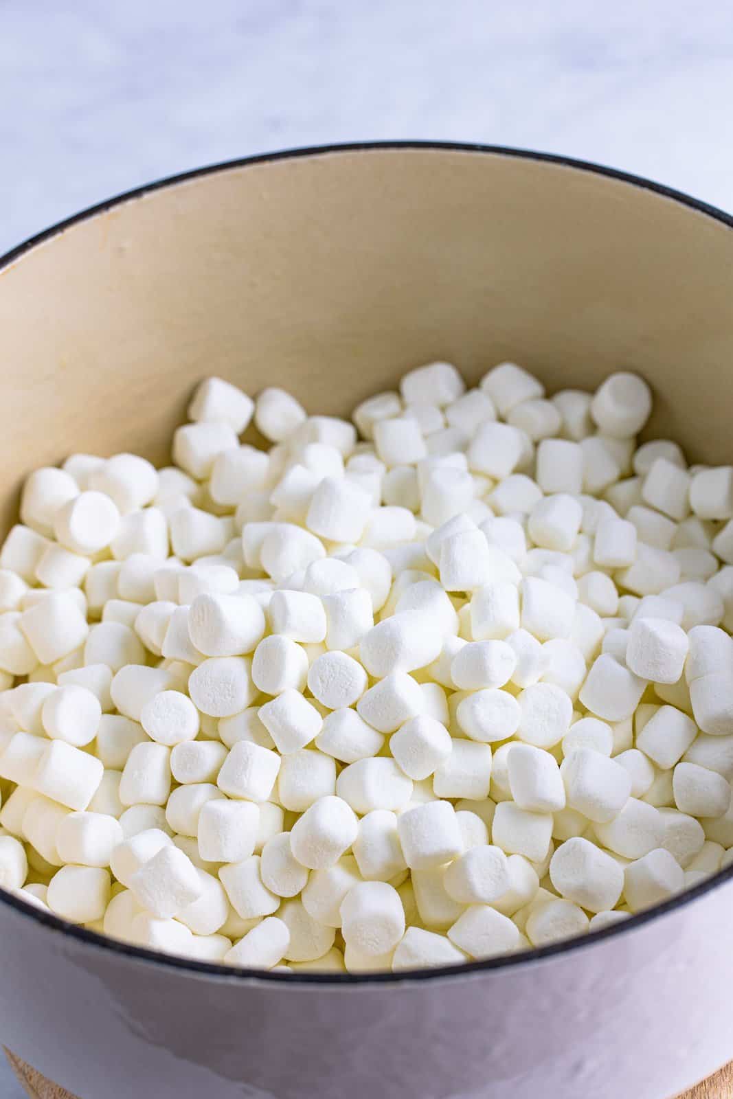 A dutch oven with mini marshmallows in it.