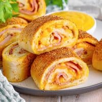 slices of ham and cheese Stromboli on a white plate.
