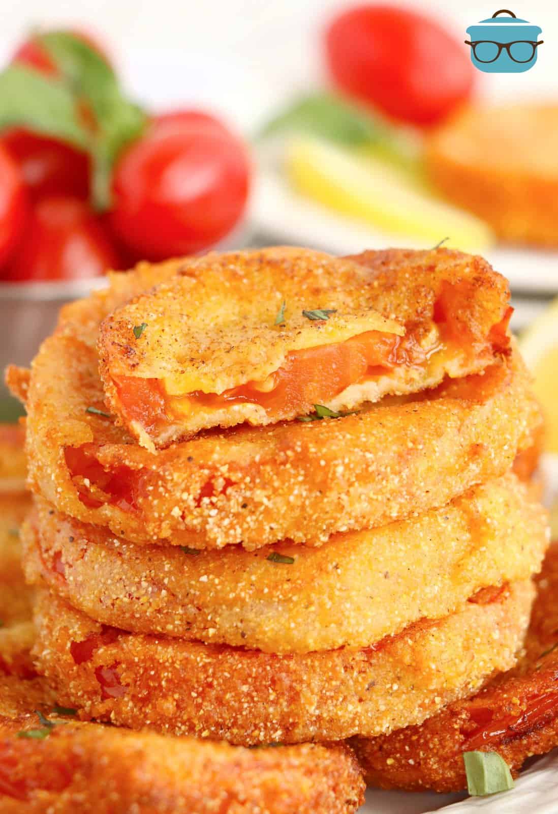 A stack of breaded and Fried Red Tomatoes. 