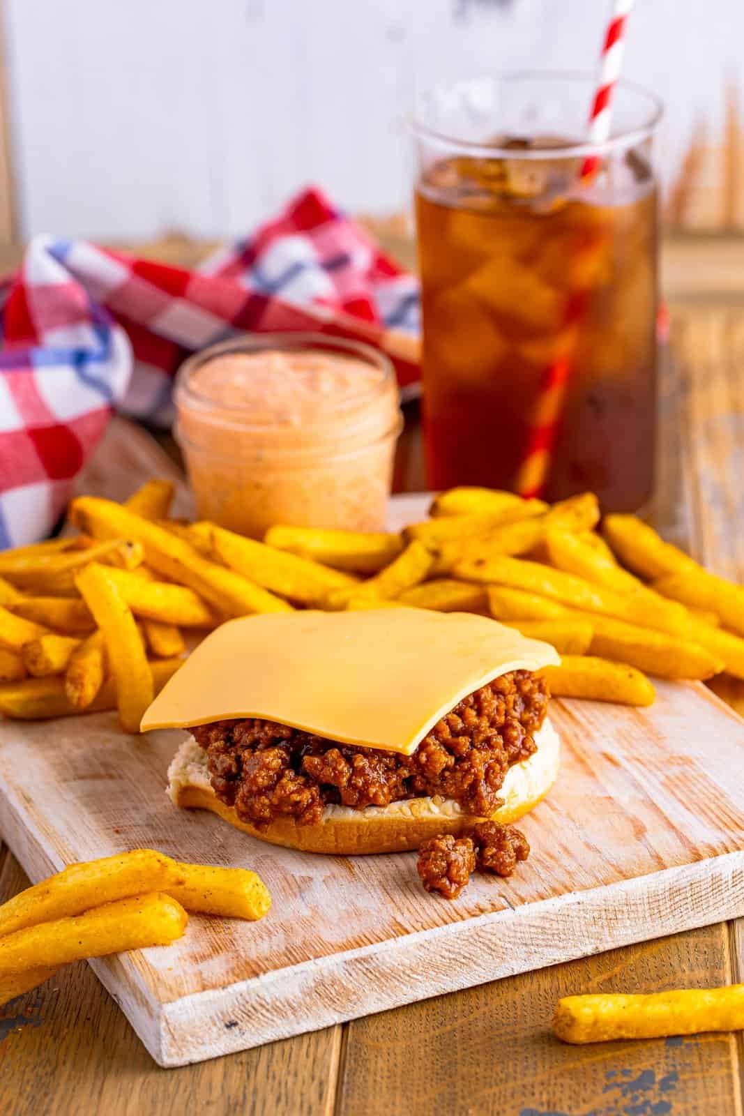 The start of a Big Mac Sloppy Joe sandwich with french fries.