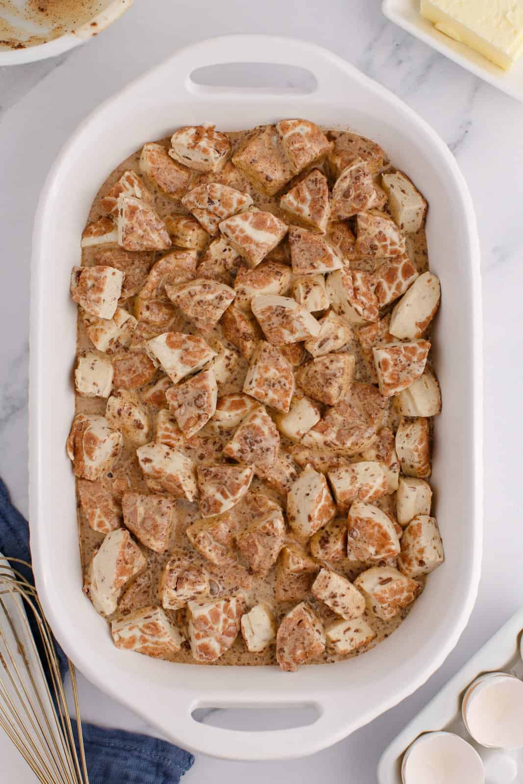 An uncooked Cinnamon Roll Casserole in a baking dish.