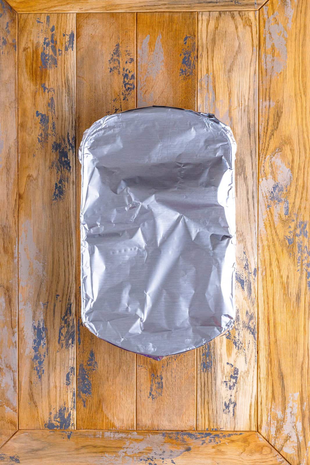 A baking dish covered with aluminum foil. 