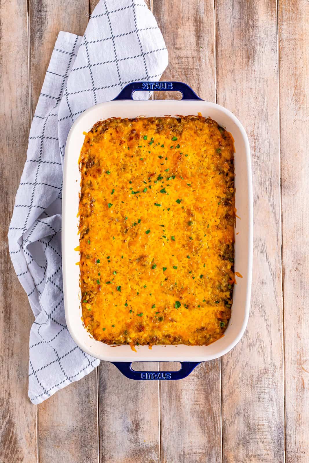 A casserole dish with cheese melted on top of a casserole.