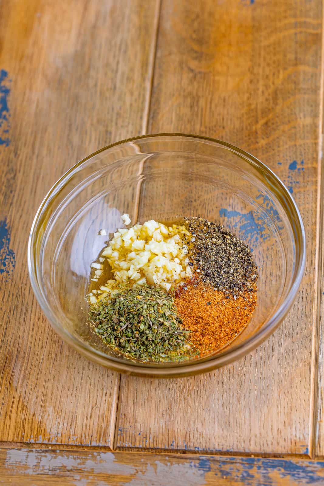 Honey, garlic, Italian seasoning, creole seasoning, and black pepper together in a small bowl