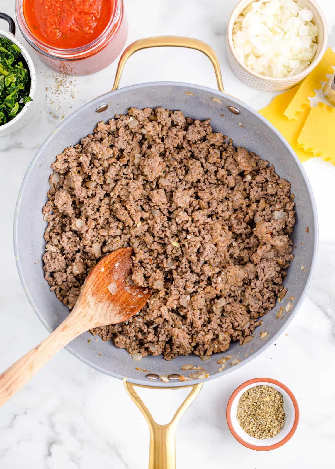 Cooked ground beef and onion in a skillet. 