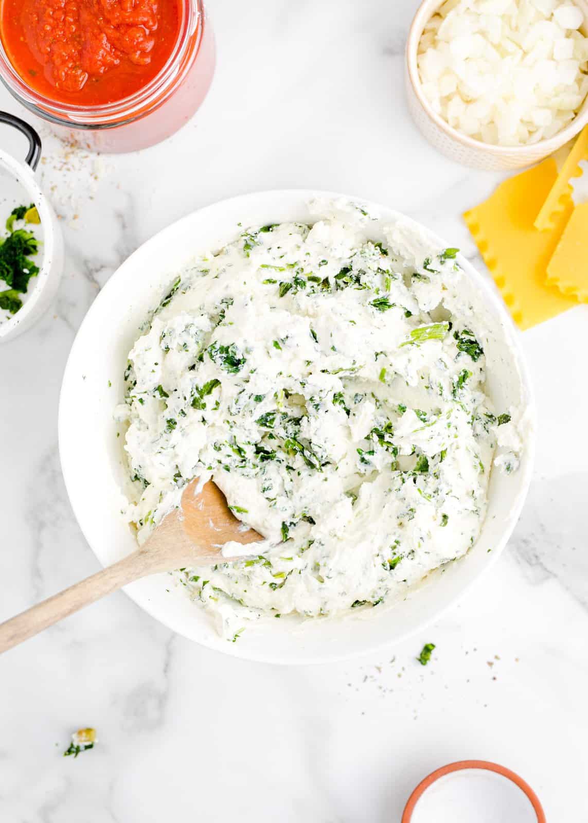 A bowl of ricotta cheese and spinach. 