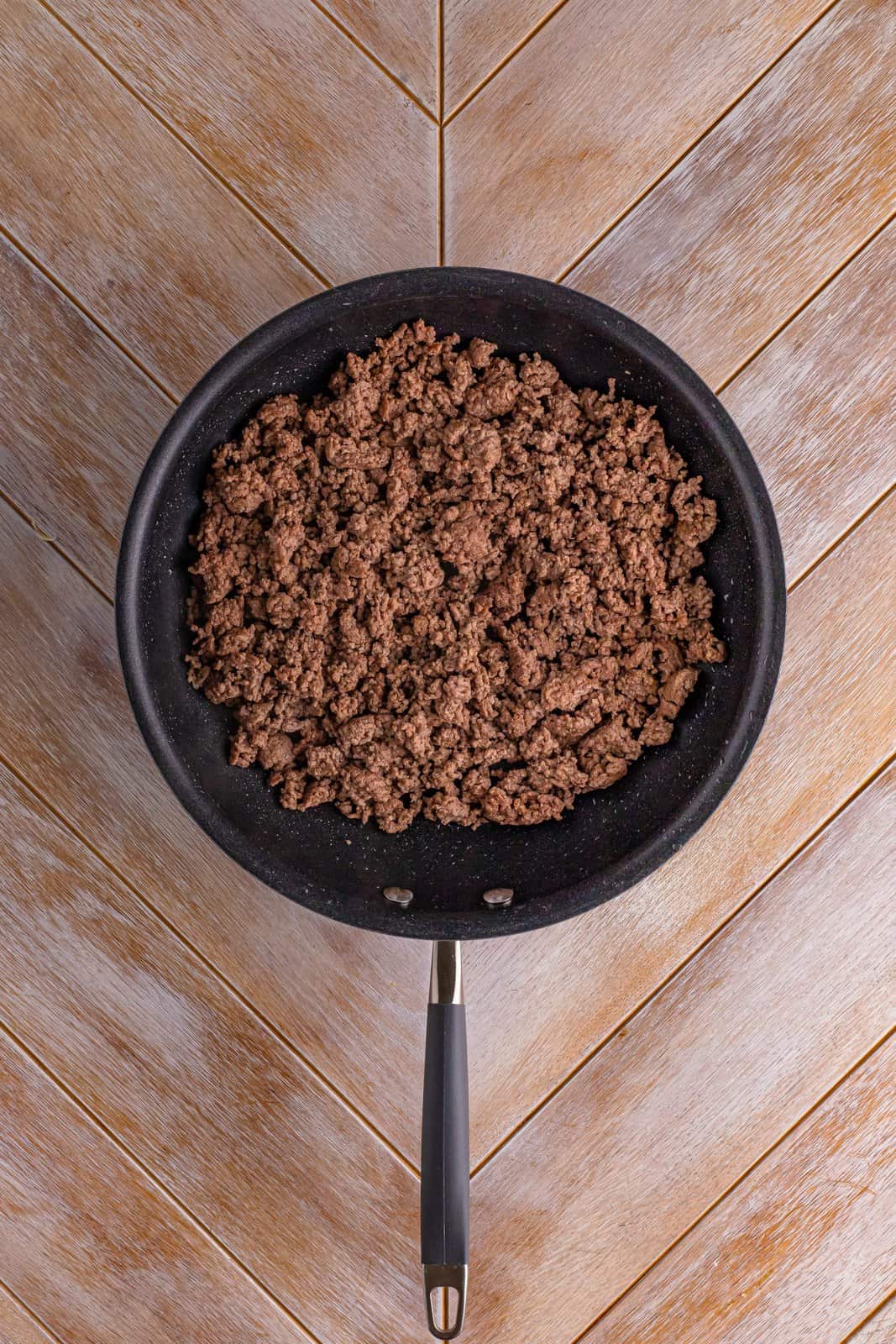 A skillet of cooked ground beef.