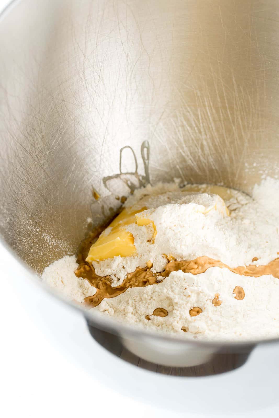 A mixing bowl with flour, vanilla, butter, salt and other things.
