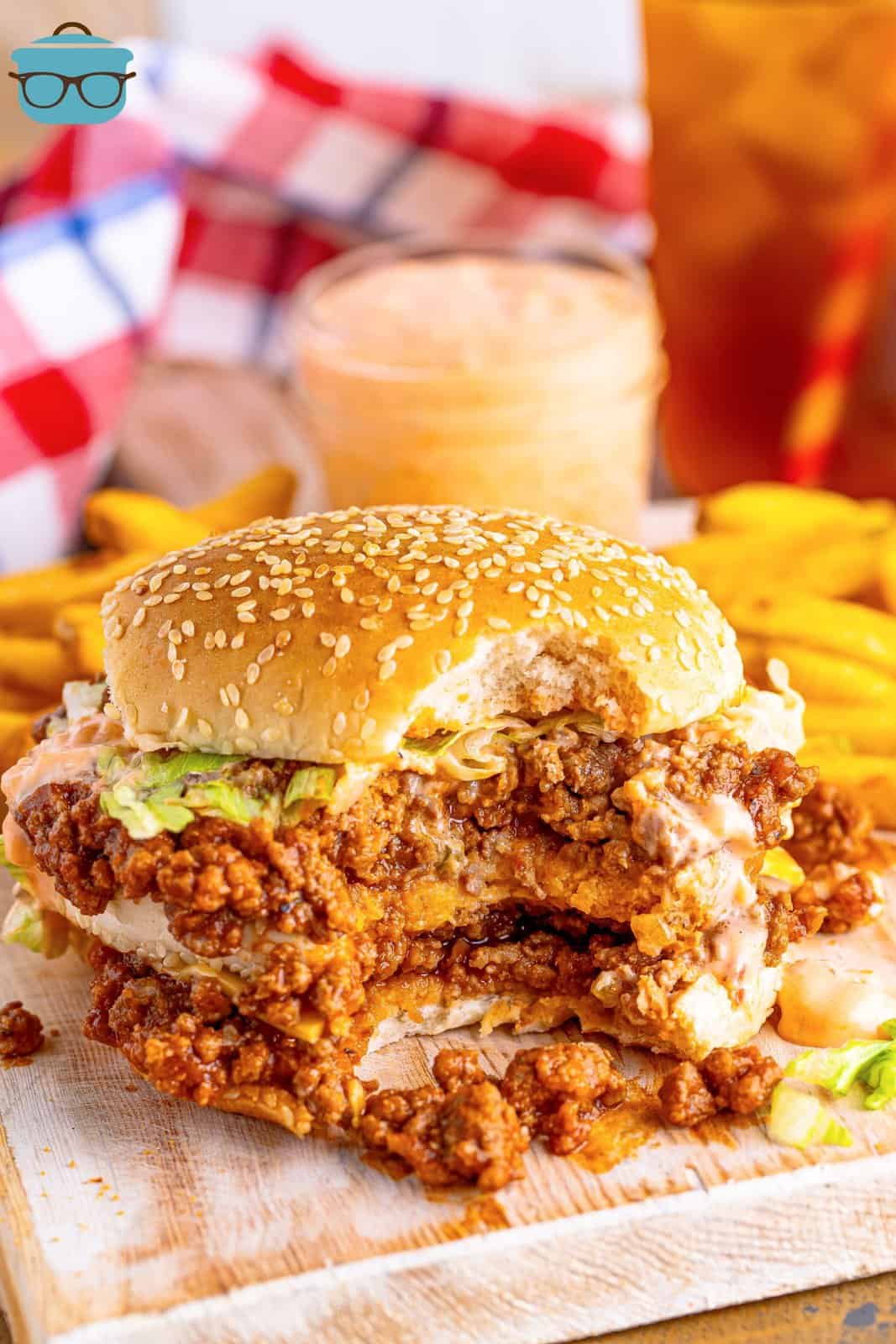 A Big Mac Sloppy Joe sandwich with a bite taken out and fries behind it.