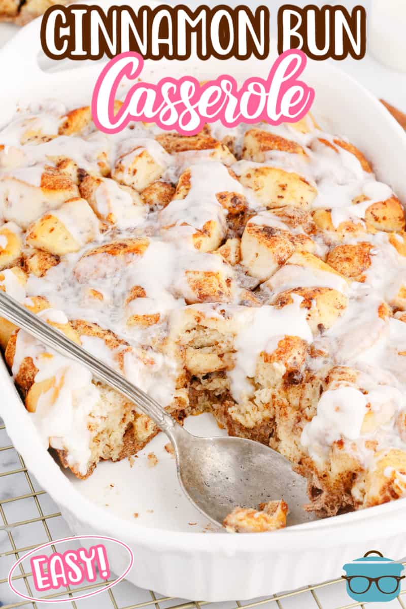 A baking dish with a Cinnamon Bun Casserole with a serving taken out.