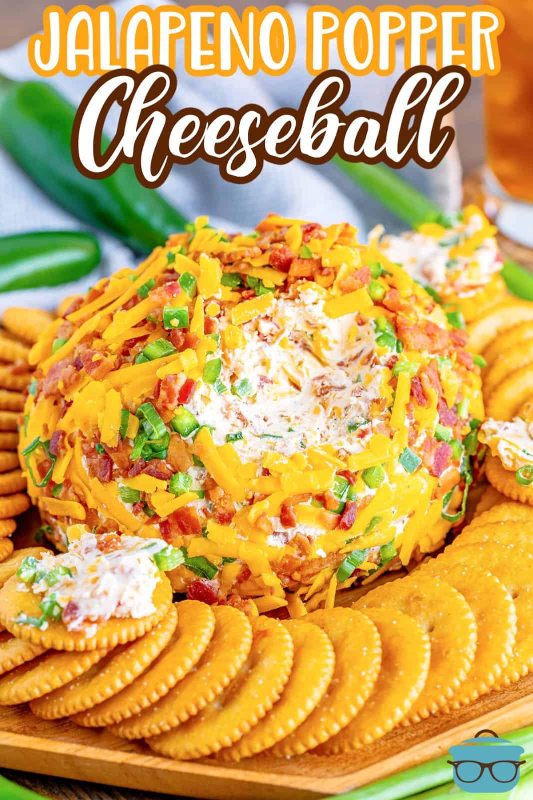Crackers surrounding a cheeseball with jalapeno flavor, bacon, and chives.