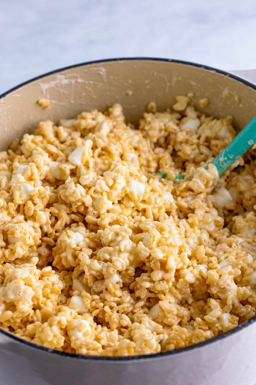 Rice Krispie Treat mixture in a pot with spatula.