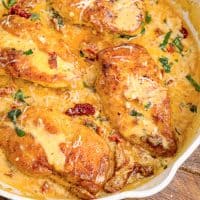 A close up of Marry Me Chicken in a dish with, rich and creamy cheesey sauce.