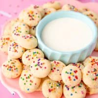 A pink plate of mini sweetened condensed milk cookies.