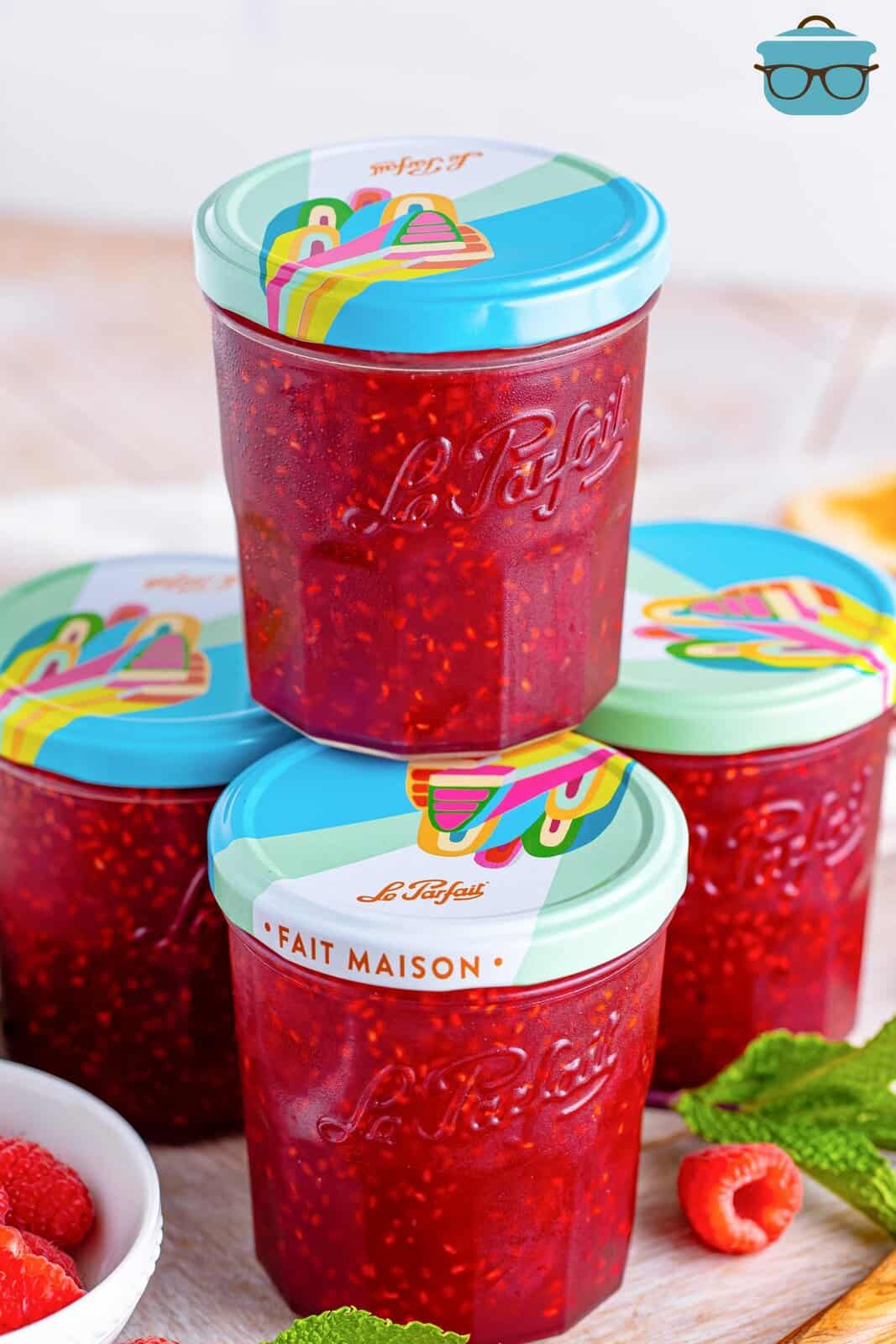 Jars of raspberry jam stacked up.