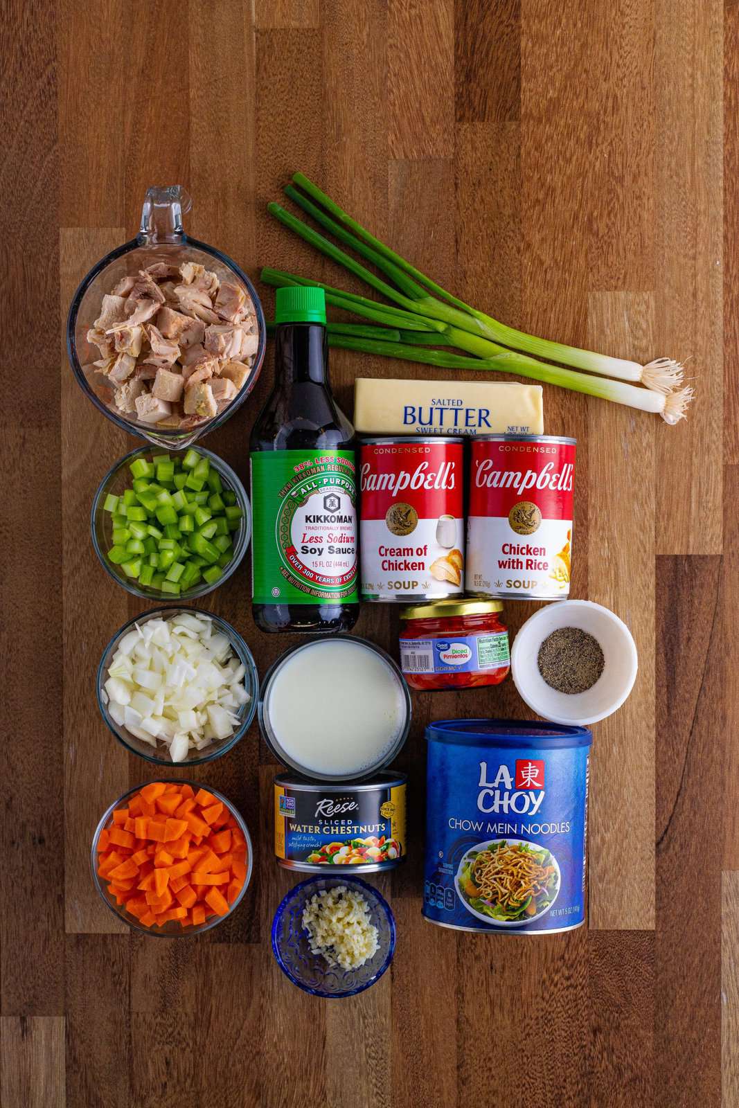 Salted butter, celery, onion, carrots, garlic, diced pimento, water chestnuts, can of cream of chicken soup, can of chicken and rice soup, milk, pepper, low sodium soy sauce, diced chicken, chow mein noodles, and green onions. 