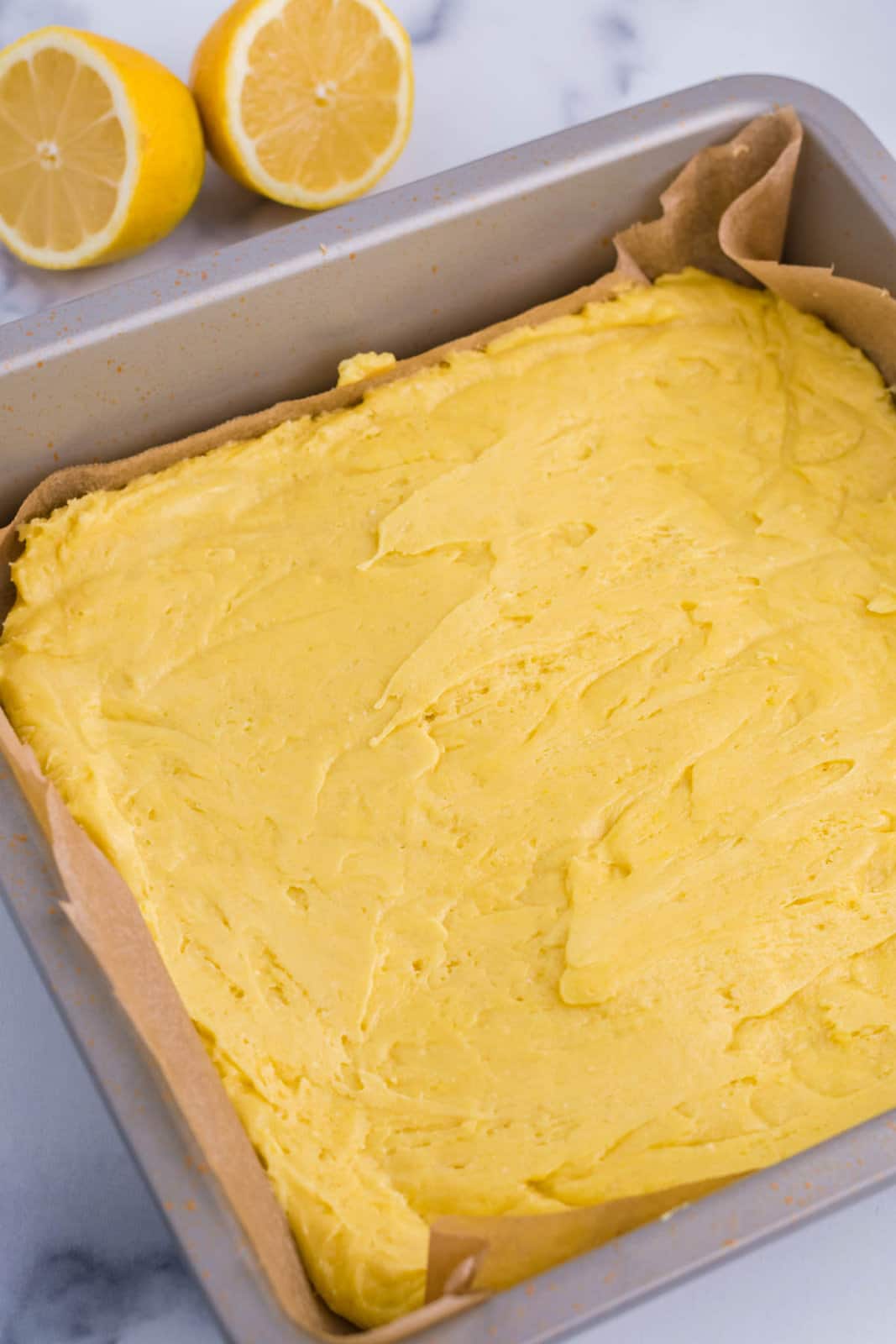 Lemon Brownies ready to be baked in a baking dish.