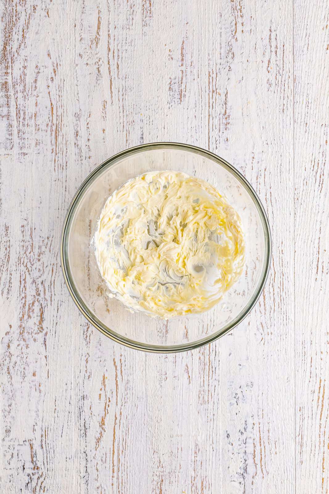 A mixing bowl with cream cheese.