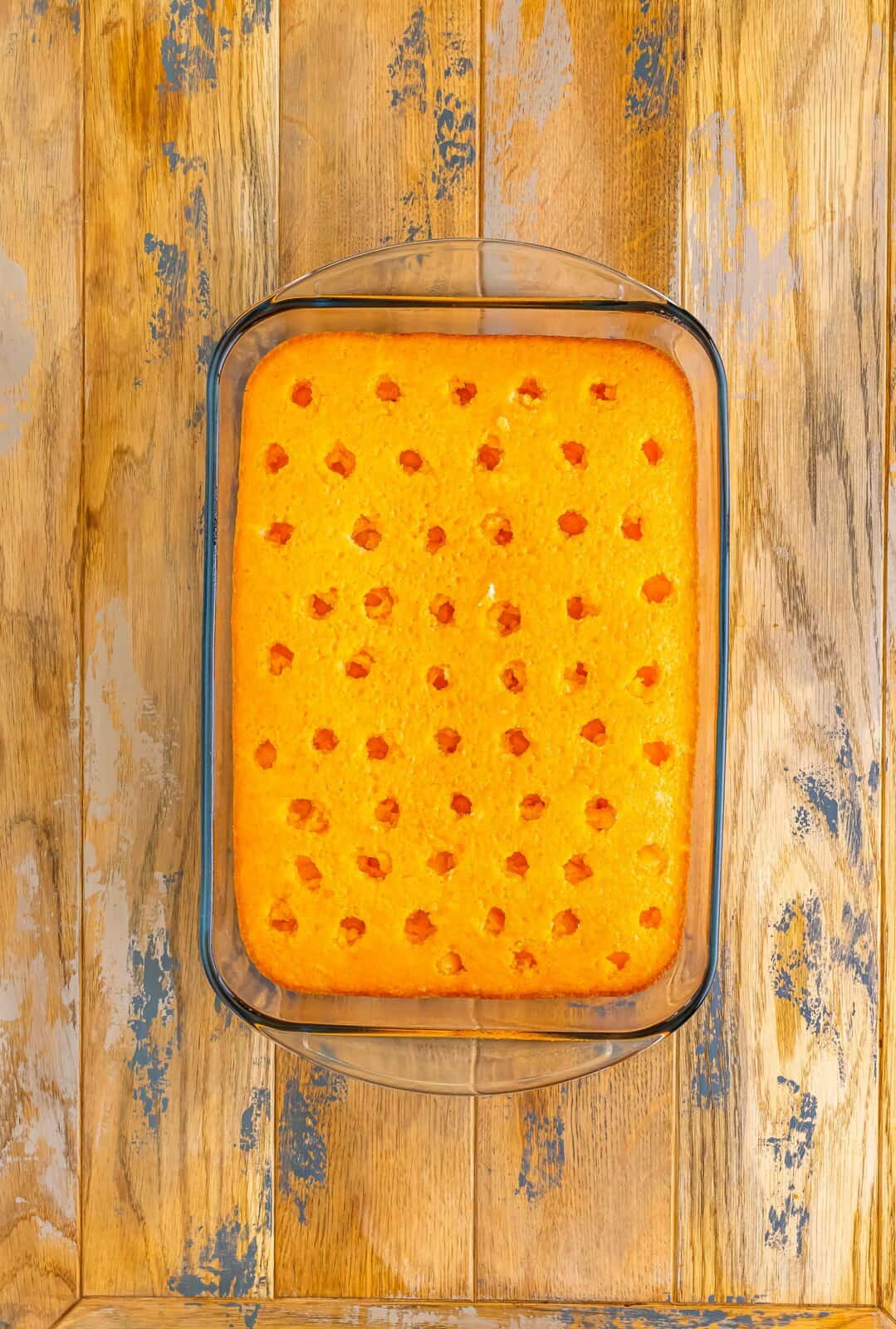 A cake with holes poked in the top and jello poured in the holes.