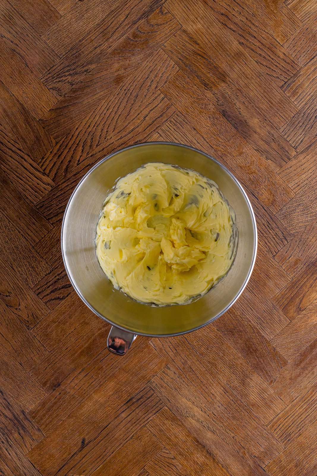 A glass bowl with beaten salted butter.