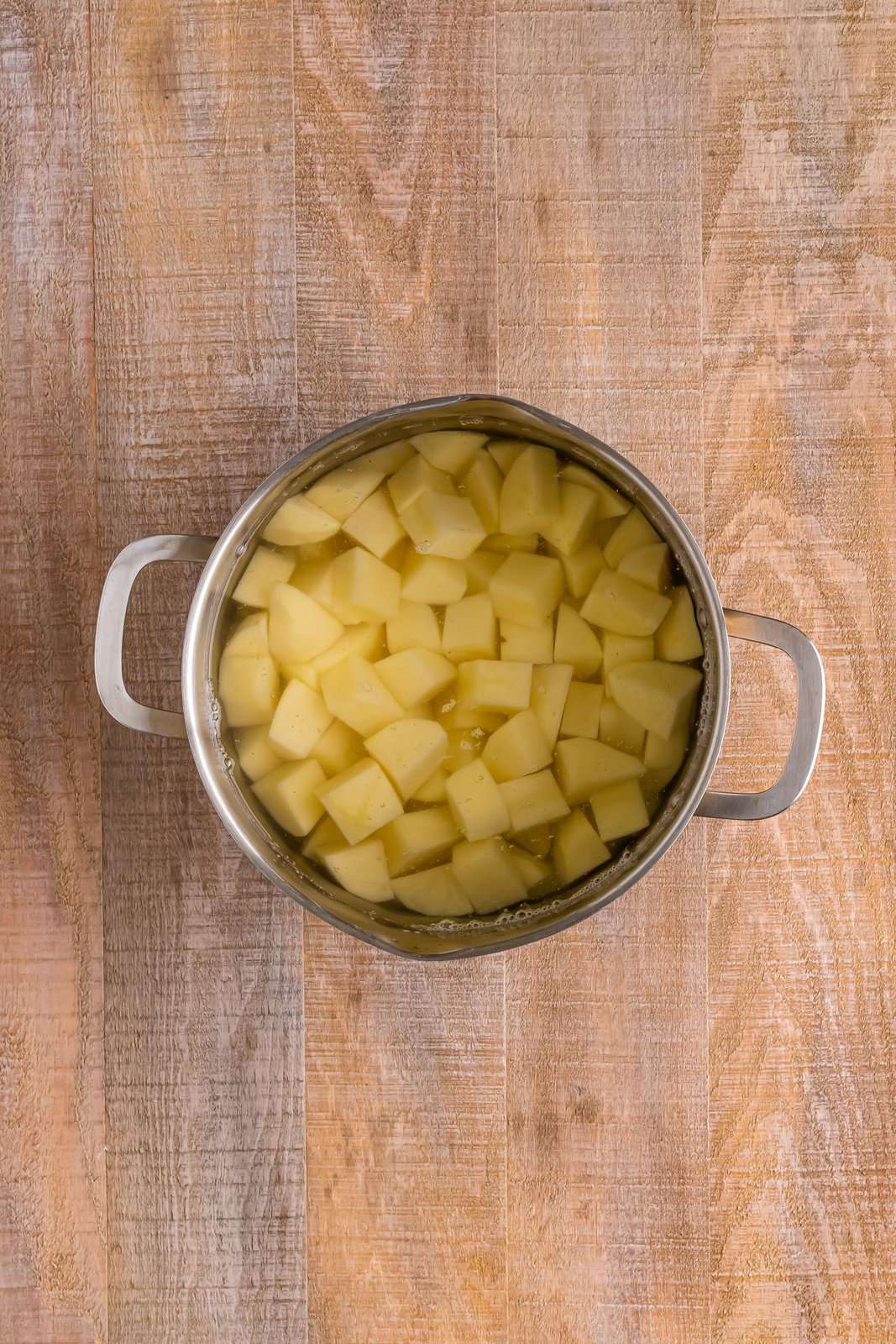 A pot with potatoes waiting to be boiled.