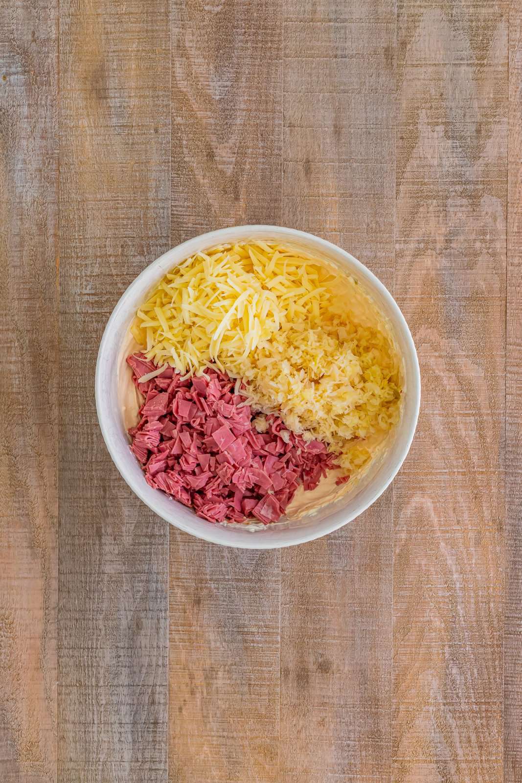 Sauerkraut, corned beef, and Swiss cheese on top of the rest of Reuben Dip.