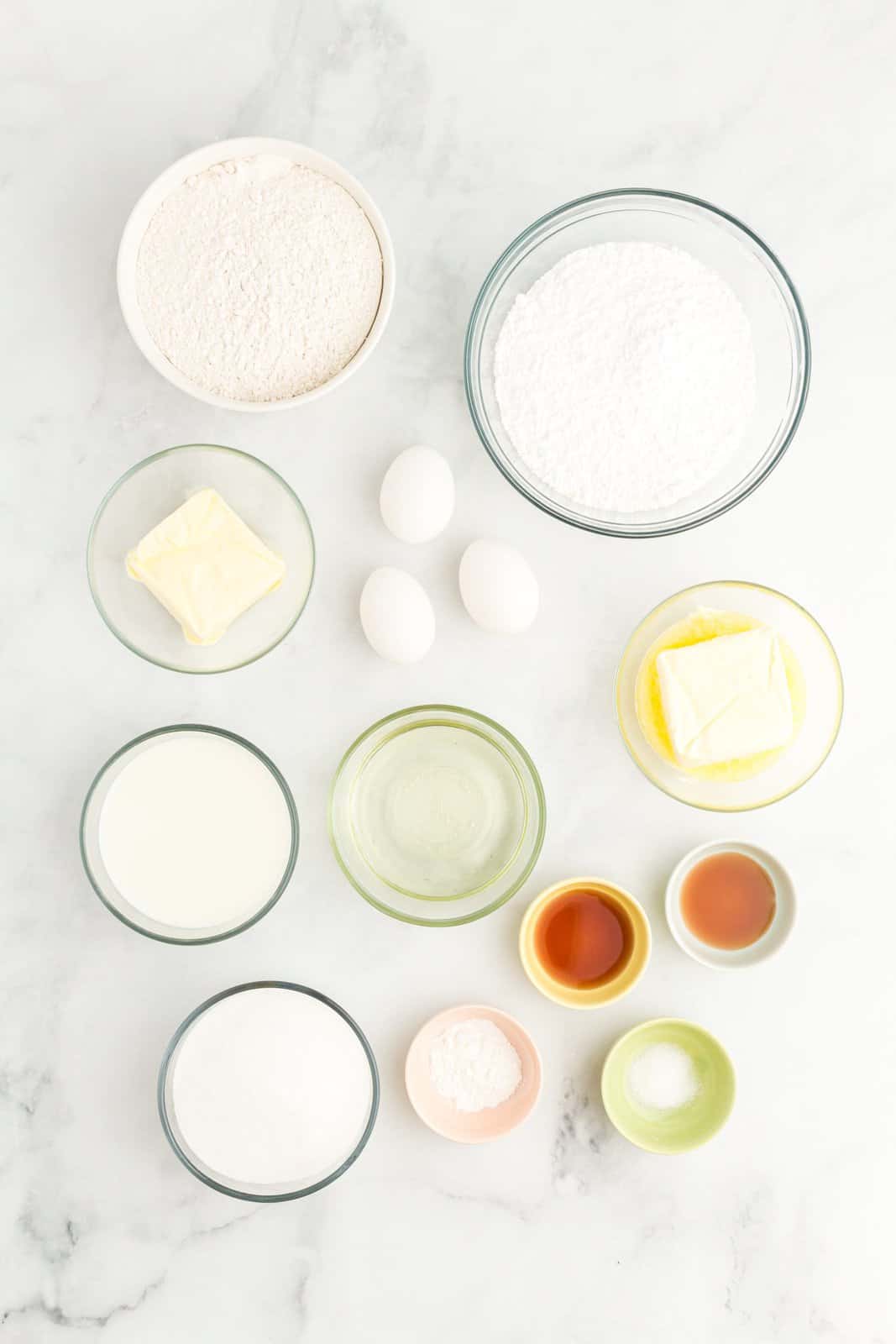 flour, baking powder, salt, unsalted butter, sugar, oil, eggs, vanilla extract, milk and powdered sugar. 