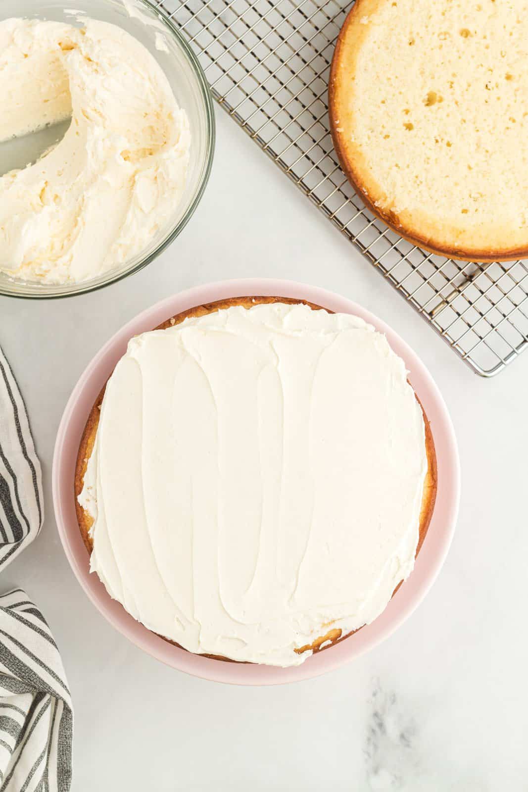 A white cake with homemade frosting on top.