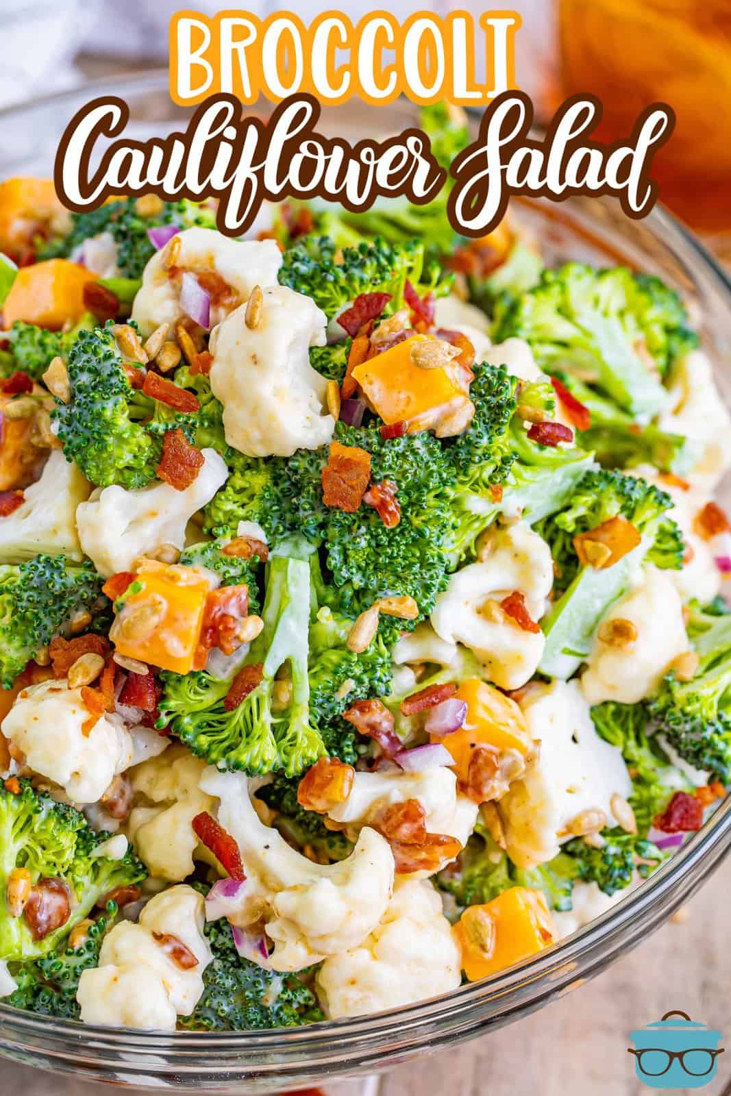 Looking down on a bowl of broccoli cauliflower salad with bacon.